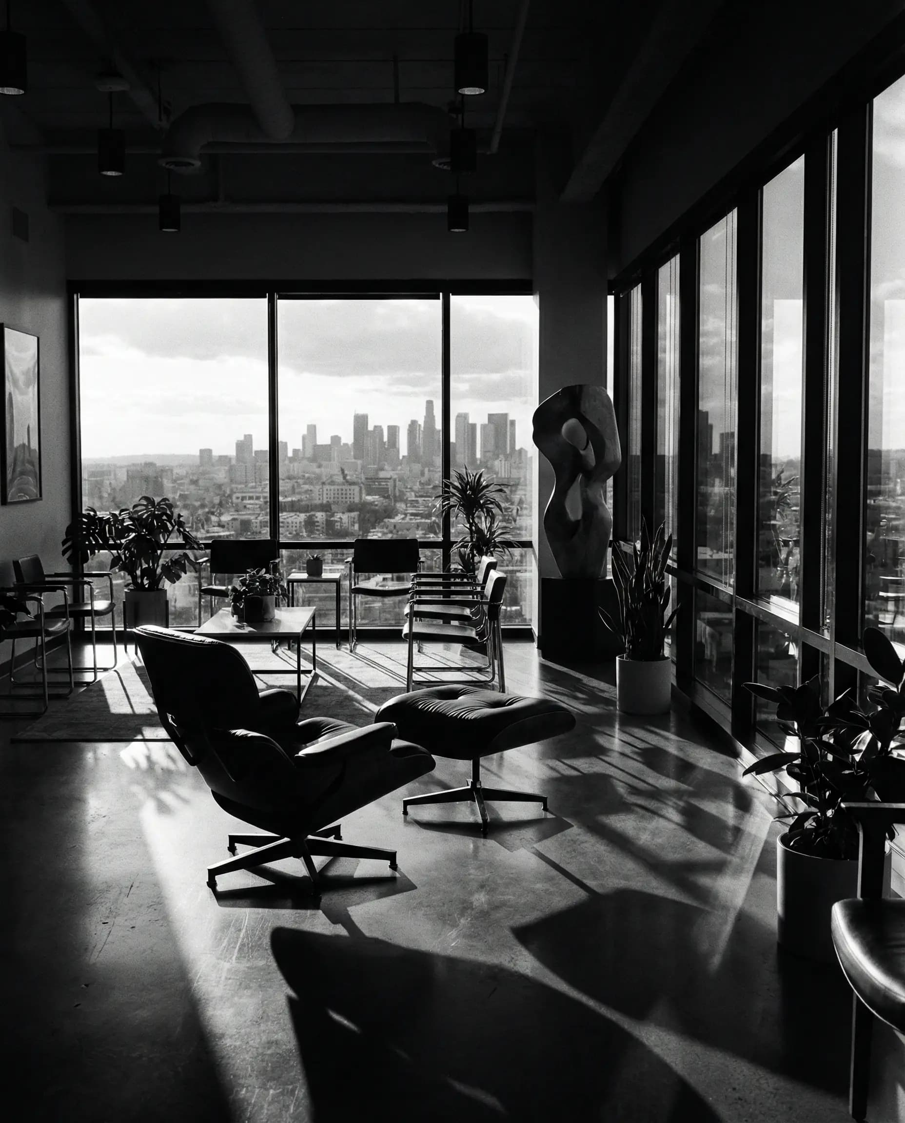 Modern office with Eames chair overlooking city skyline